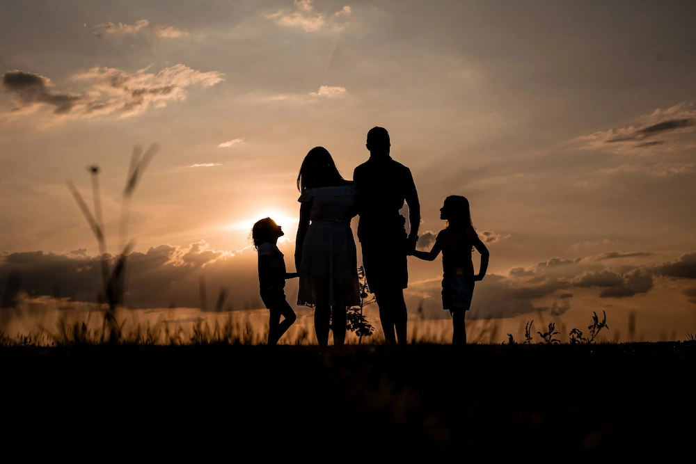 Silhouette of a family against the sunset